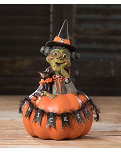 Whimsical Halloween figurine featuring a green-skinned witch with a pointed hat, seated inside a pumpkin adorned with a 'wicked' banner, accompanied by a black cat at her side; designed by LeeAnn Kress for Bethany Lowe.