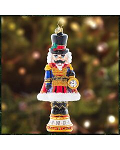 The Countdown to Christmas ornament features a distinguished nutcracker proudly holding a golden pocket watch as he eagerly awaits the big day. With rich holiday colors and shimmering details, this festive figure captures the joyful anticipation of Christ