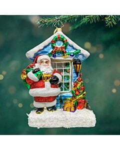 Santa Claus stands cheerfully outside a festive window, holding a sack brimming with presents. His joyful gaze and holiday spirit capture the magic and warmth of the season.