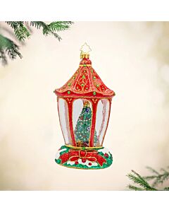 A festive lantern ornament reveals a twinkling Christmas tree and a cozy bear nestled inside. Its warm glow and whimsical scene capture the magic and charm of the holiday season.