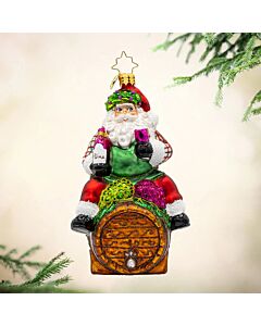 I Believe in Wine Santa ornament featuring Santa perched on a barrel, savoring a glass of wine with festive cheer. This whimsical decoration adds a humorous and sophisticated twist to holiday décor for wine lovers.