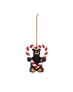 Hand-cast ornament from the Bearfoots Collection, depicting a cheerful black bear holding a candy cane shaped into a heart, designed by Jeff Fleming.