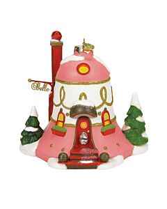 A charming pink and white North Pole house adorned with gold glitter accents, red-trimmed windows, and a bell-shaped front door featuring a large clear jewel. A golden sign reading "Belle" hangs above the entrance, and the house is led by Belle and her ha