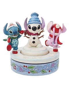Stitch and Angel, bundled in winter gear, twirl with joy around a whimsical snowman they’ve built, their playful energy radiating holiday cheer in this enchanting Jim Shore figurine.