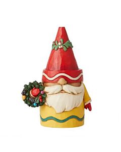 This whimsical Jim Shore gnome figurine showcases vibrant Crayola-inspired colors as he proudly displays Christmas wreaths. The charming garden dweller wears a festive wreath-adorned cap and carries another wreath in his red-gloved hand, bringing heartwar
