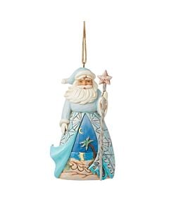 Santa in a flowing blue cloak holds a starfish-tipped cane, revealing a moonlit coastal scene beneath—a serene holiday tribute to the sea