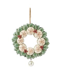 A unique twist on a traditional Christmas motif, this Jim Shore ornament is a stunning and serene coastal creation with sand dollars and holly.