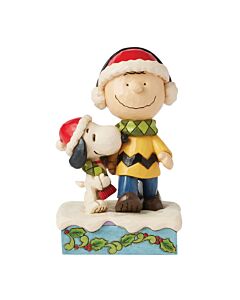 Jim Shore’s Bundled In Friendship figurine featuring Snoopy and Charlie Brown holding hands, wearing matching Santa hats and sharing a cozy scarf, capturing the warmth and joy of the holiday season.