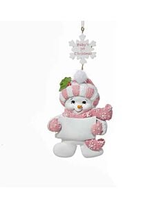 This darling snow baby girl ornament marks the joy of a little one’s very first Christmas. Bundled in a cozy hat and scarf, she holds a blank banner ready to be personalized with a name or date.