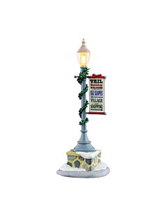 The Vail Lamp Post, wrapped in garlands, lighting the way to cozy cafes and magical shopping spots