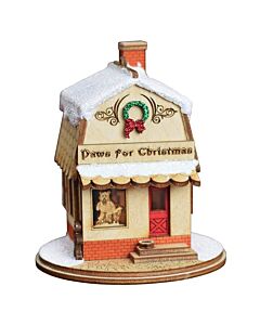 A quaint, snow-dusted pet shop ornament by Ginger Cottages, showcasing warm, inviting details. Insert a Christmas tree light to illuminate the interior, unveiling a delightful scene inside.