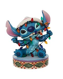The beloved blue experiment gets adorably wrapped up in Christmas preparations, literally tangled in colorful holiday lights while sporting a festive red Santa hat. This hand-painted stone resin collectible showcases Jim Shore's signature folk art style w