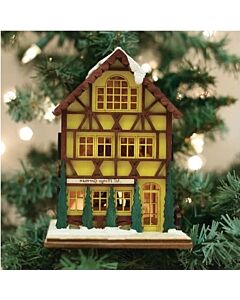 Charming miniature German house ornament with snow-dusted roof and warm glowing windows, featuring traditional Alpine architecture and ready to illuminate your Christmas tree with festive light