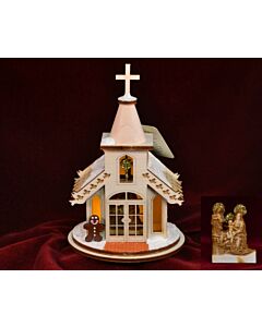 Delightful nativity chapel ornament crafted as a quaint, snow-topped church, accented with a cheerful gingerbread man—designed to illuminate softly when placed over a Christmas tree light, capturing festive warmth and whimsy.