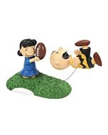Lucy holds a football ready to trick Charlie Brown once again in this classic autumn scene, capturing a beloved Peanuts tradition.
