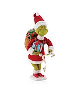 The Grinch stands tall in his festive red Santa suit with white fur trim, carrying a brown sack of colorful gifts over his shoulder while holding a blue present and his naughty-and-nice list. His heart might have grown three sizes that day, but his mischi