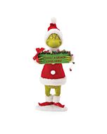 A whimsical figurine of the Grinch stands, holding a sign that humorously warns, "A Grinch lives here. Beware." His iconic green form and mischievous expression are perfectly captured in this detailed collectible.