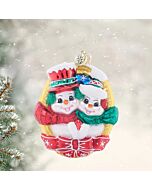 Christopher Radko 'A Picture Perfect Pair' features two adorable snow characters posing together, framed in gold and finished with a festive bow. This glass ornament captures a charming and photo-ready moment for your holiday tree.