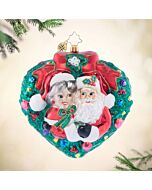 Mr. & Mrs. Claus share a sweet moment under the mistletoe, capturing the warmth and charm of the holiday season. This delightful ornament adds a touch of festive romance to your tree with Santa and Mrs. Claus embracing in a heartwarming scene.