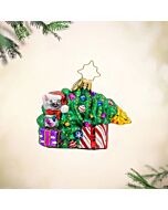A mischievous kitten tumbles through a toppled Christmas tree, scattering presents in playful chaos. Its wide-eyed curiosity captures the lively, unpredictable spirit of the holiday season.