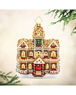 A charming Gingerbread Manor ornament decorated with candy accents and frosted details, evoking a sweet holiday home. Its whimsical design brings festive warmth and playful cheer to Christmas décor.