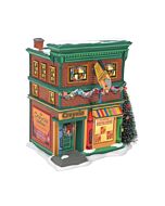 The Crayola Crayon Store building in Snow Village bursts with playful charm, featuring a bright primary-colored awning and oversized crayons lining the storefront. This whimsical collectible invites visitors to a world where creativity and color are alway