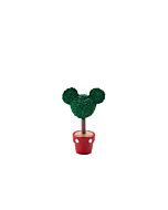 Green topiary shrub sculpted in the iconic shape of Mickey Mouse, adding a whimsical touch to the village scene.