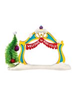 Colorful welcome arch styled in whimsical Whoville fashion, featuring curved posts, festive trim, and a decorated Christmas tree nestled alongside.
