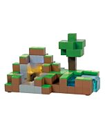 A Minecraft-themed village piece featuring layered block landscaping with a waterfall pond above a glowing subterranean diamond mine.