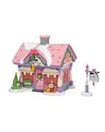 Charming village building designed as Minnie's Shoe Boutique, adorned with festive decorations and whimsical details celebrating her love for fashionable footwear.