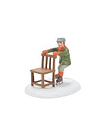Village scene of a bundled-up child learning to skate by pushing a sturdy wooden chair across an icy surface.