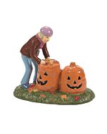 Autumn-themed village accessory featuring a resident filling pumpkin-shaped leaf bags during seasonal yard cleanup.