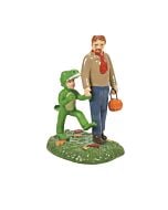 Charming Halloween village figure of a child in a green T-Rex costume holding hands with his dad while trick-or-treating.