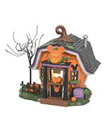 Pumpkintown Carving Studio with bright pumpkin-orange walls and mansard roof, featuring Mickey logos on the door and windows, the place where the best jack-o-lanterns are crafted.