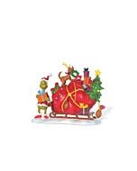 The Grinch and Max share a heartfelt moment as they ride a sled together, with a large bag of gifts symbolizing the Grinch’s transformation and holiday redemption.