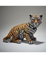 A striking sculpture of a tiger cub by Matt Buckley, capturing the playful nature of the young tiger with intricate, hollow carvings of stripes and hand-painted shades of orange and white.
