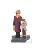 Village figurine of a child holding a greeting card beside a proud mother, depicting a heartwarming moment of picking the perfect card for Grandpa.