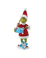 The Grinch cradles a festive gift box containing his beloved dog Max, who peeks out wearing decorative antlers like a tiny reindeer. Silver tinsel sparkles around Max as he sits snugly in his candy cane-striped present box, bringing Christmas magic to lif