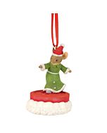 A whimsical Christmas ornament featuring a mouse in a green nightgown and a Santa hat, seemingly out past bedtime, playfully snowboarding atop a large button as if sledding across a festive tree.
