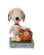Snoopy joyfully carries a vibrant basket of spring flowers, spreading petals of happiness across the Heartwood Creek landscape in this handcrafted Jim Shore figurine