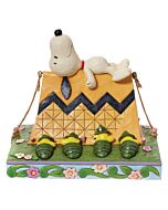 This Jim Shore figurine features Snoopy napping atop a Charlie Brown–patterned tent while Woodstock and friends camp below in ranger hats. Hand-painted with folk art detail, it captures the peaceful charm of a night under the stars.