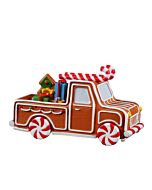 A delightful gingerbread truck, adorned with white frosting and red peppermint swirls, is perfectly loaded with gifts for holiday delivery. This sweet vehicle appears ready to spread festive cheer, crafted entirely from edible Christmas treats.