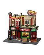 Top Pizza collectible building shaped like a classic pizzeria, featuring a large spinning pizza sign on the roof, a chef in a white hat making an “A-OK” hand gesture, and brightly lit windows revealing the chef tossing pizza dough and a rotating pizza dis