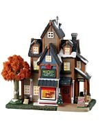 The Lemax Merry Maple Leaf building showcases a rustic shop filled with maple delights, capturing the cozy charm of country living. This inviting piece adds warmth and character to holiday village displays.
