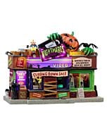 A horror fan's dream turned nightmare - this detailed miniature video store features terrifying movie posters and an ominous checkout counter where something lurks.