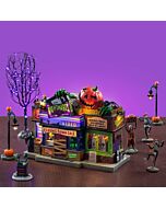 Cobwebs cling to the Nightmares Video store as skeleton villagers lurk outside, surrounded by lampposts and twisted tree branches, hinting at a dark fate for customers.