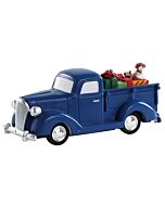 Vintage blue pickup truck laden with presents, embodying the 'Tis Better to Give' spirit, a festive LEMAX collectible accessory