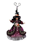 A dazzling witch figurine, richly adorned in hues of purple, black, orange, and gold, shimmers with intricate jewels and luxurious fabrics. Her elegant pose and finely detailed costume evoke a sense of enchanting nocturnal mystery.