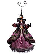 A dazzling witch figurine, richly adorned in hues of purple, black, orange, and gold, shimmers with intricate jewels and luxurious fabrics. Her elegant pose and finely detailed costume evoke a sense of enchanting nocturnal mystery.