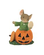 A cheerful mouse carver poses with a jack-o-lantern, proudly holding a pumpkin seed and sporting a sparkly crystal collar, showcasing his artistic creation.
